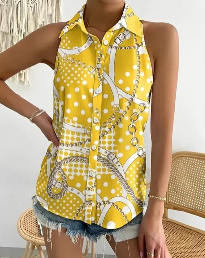 Sleeveless yellow printed blouse with chains and polka dots